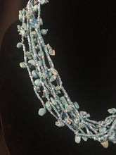 Load image into Gallery viewer, Multi-strand necklace of pale blue glass beads with block tabs; treasure-style;

