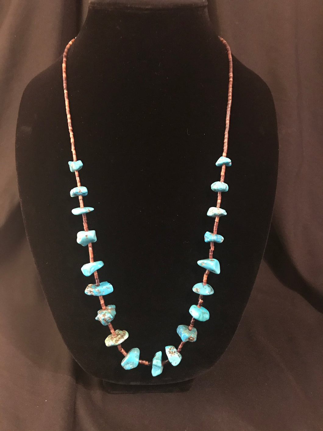 Single strand pin shell rolled beads and treated turquoise nugget necklace.