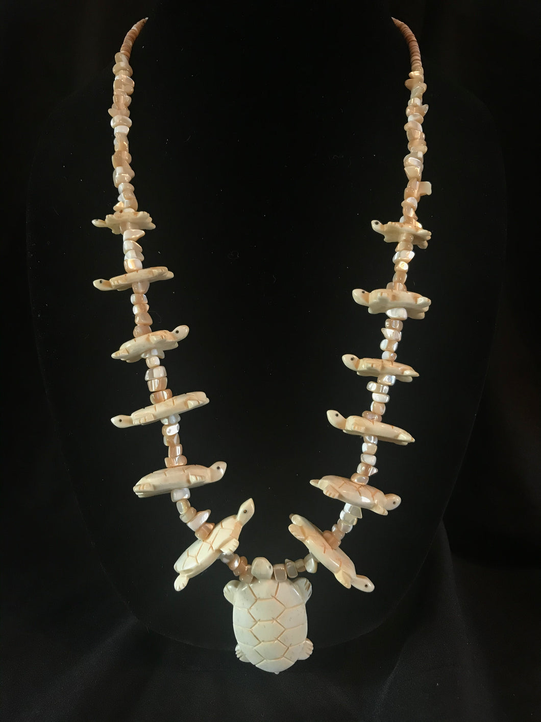 Single strand mother-of-pearl turtle carving necklace.