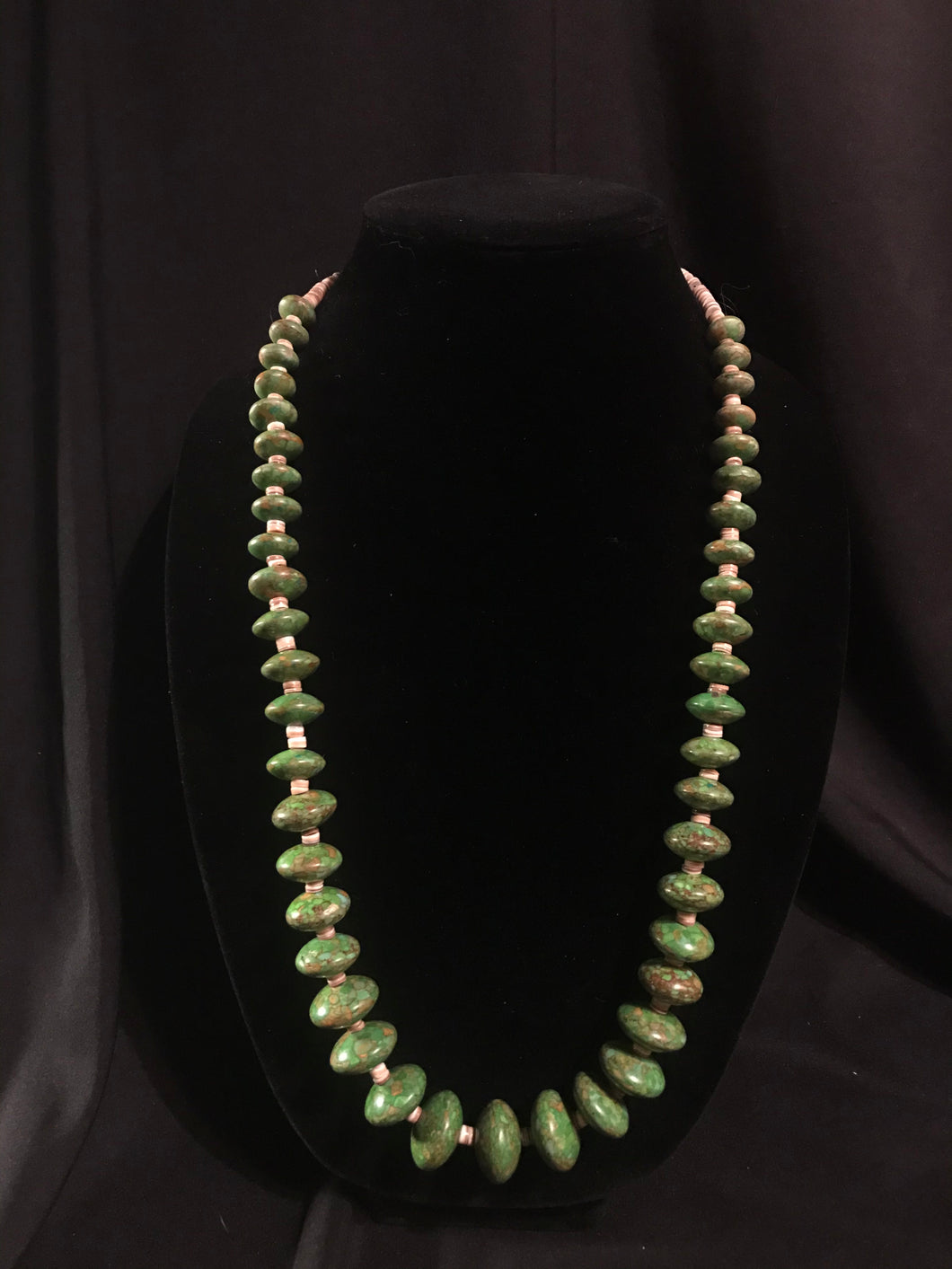 Single strand necklace of olive heishi beads interspersed with machine-shaped róndels.
