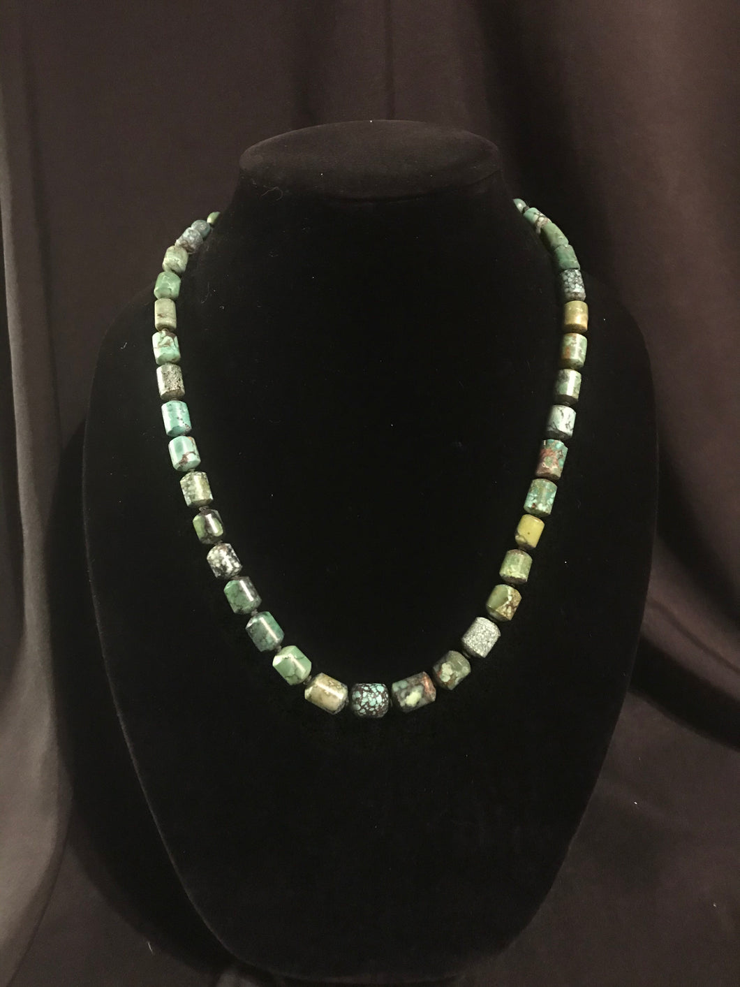 Single strand necklace of barrel shaped beads turquoise in color