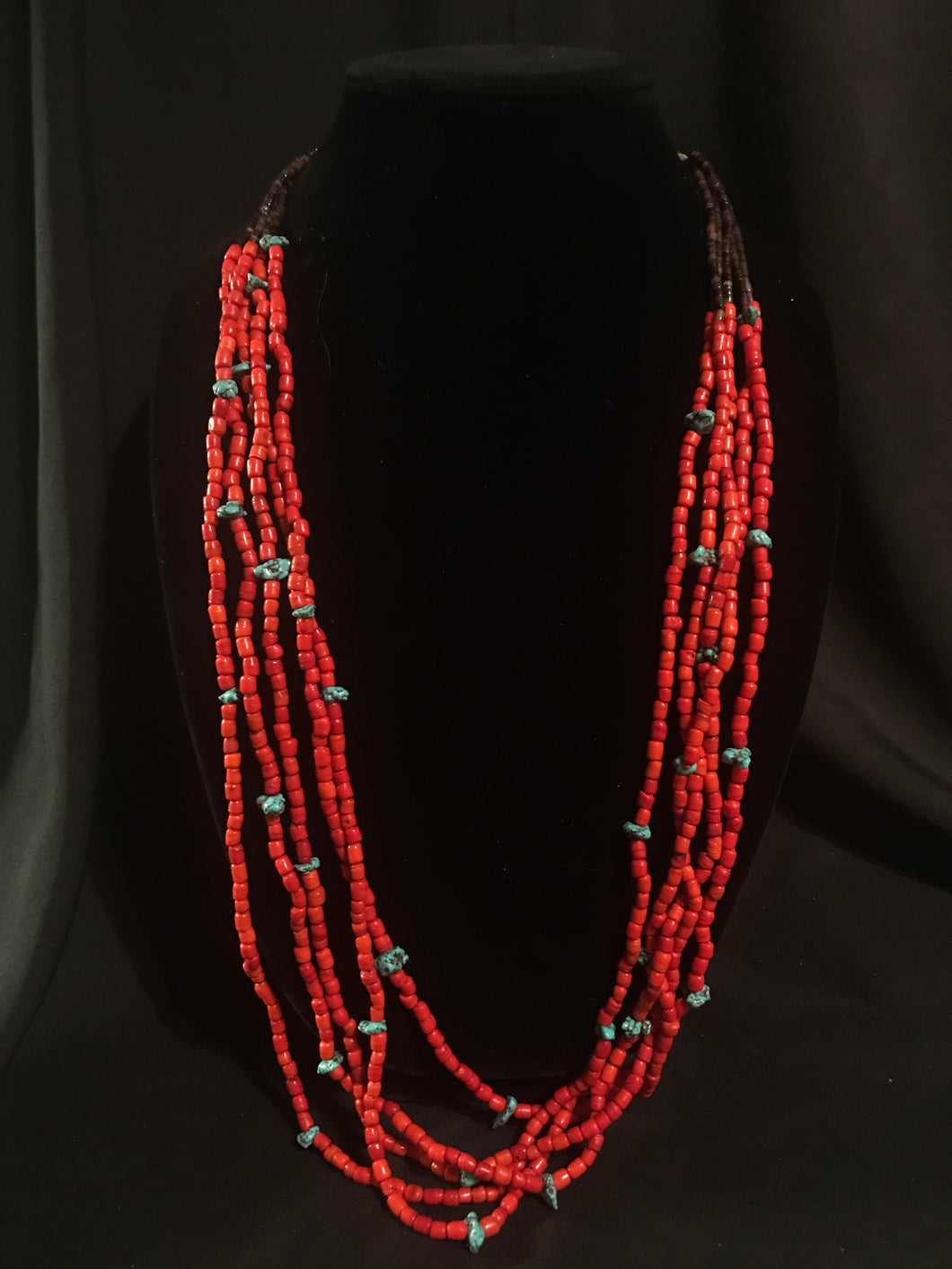Five strands of red glass bead necklace with small turquoise nuggets