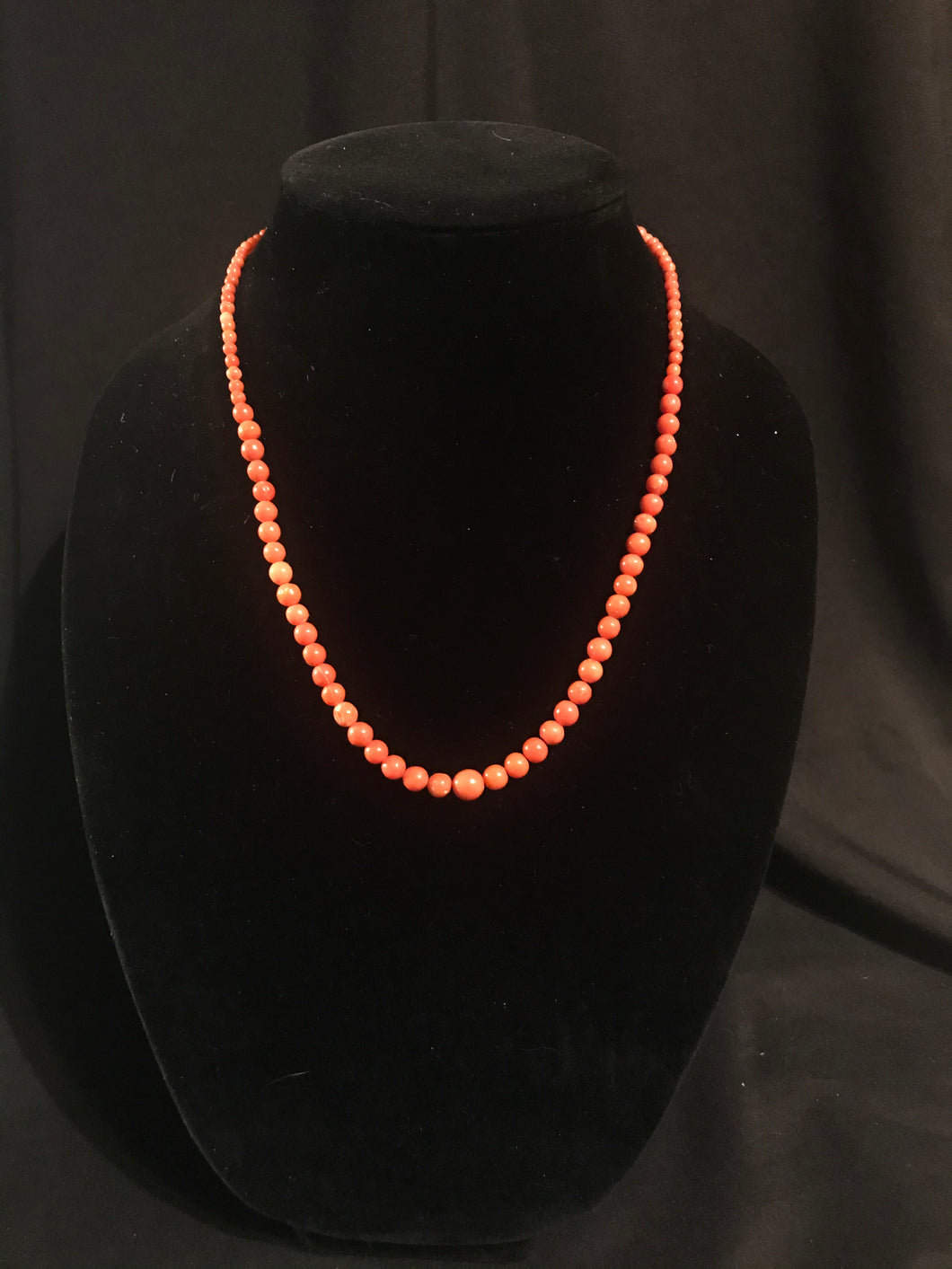 Single strand of graduated round coral beads with matching earrings