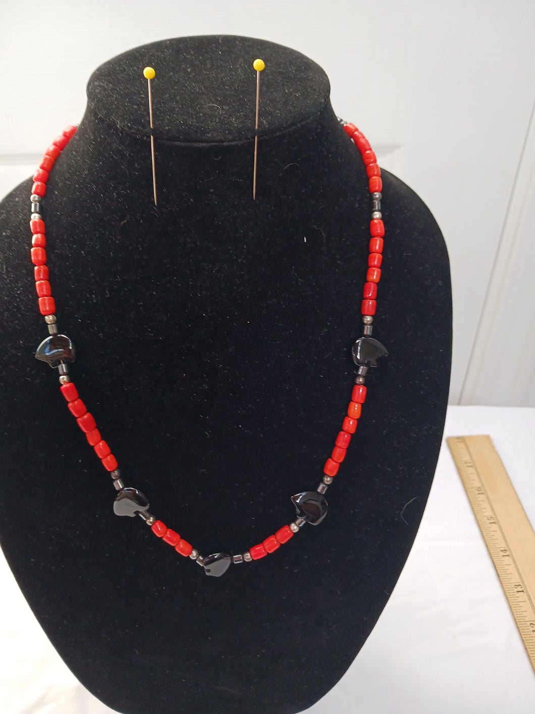 Necklace of red spun glass with carved black bears
