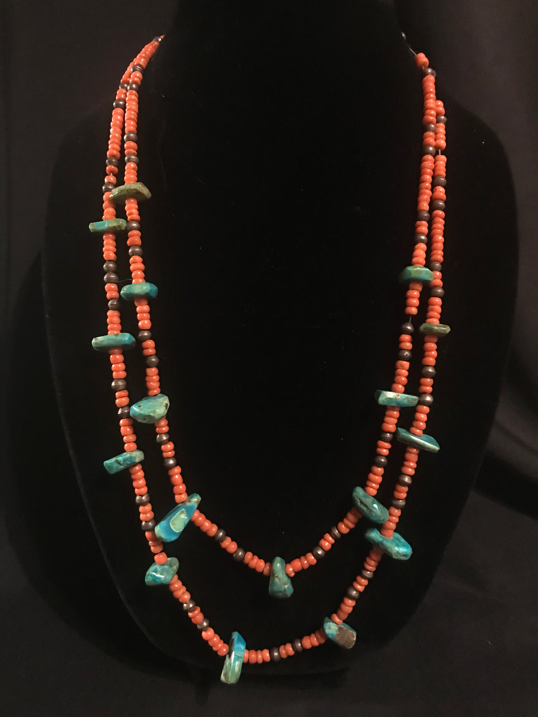 Two strands of orange coral beads with turquoise tabs; Santo Domingo pueblo