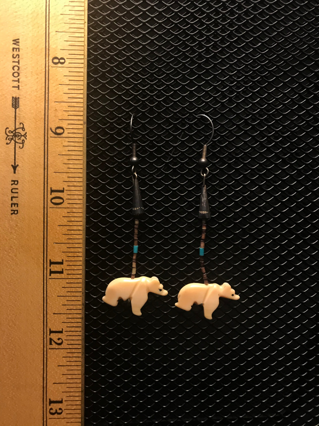 Silver colored hook earrings with dark beads and white bear fetish. Approximately 2.5” dangle.