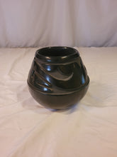 Load image into Gallery viewer, Black Pot with carved Awanyu (water serpent)Tewa deity by Stella Chavarria (1939 - 1999)
