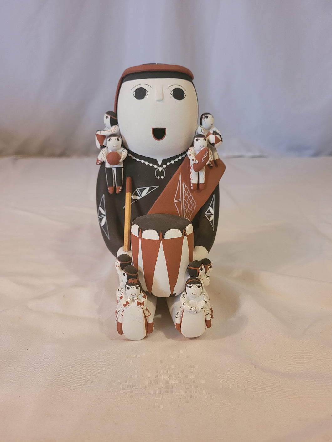 Cochiti Pueblo Story Teller with 10 children and a drum in her lap by Mary Evangeline (Vangie) Suina